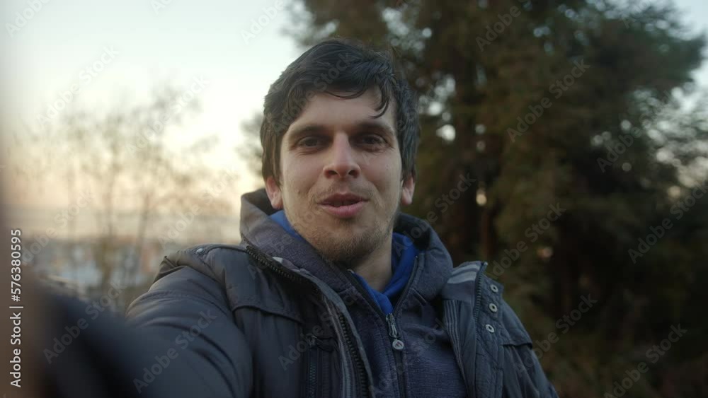 Handsome Young Man with Beautiful Hair Having a Video Call in Pov View Against Sunset Sky and Trees Background Handsome Young Man with Beautiful Hair Having a Video Call in Pov View Against Sunset Sky and Trees Background