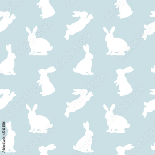 Seamless pattern with white rabbit silhouette  in different position on blue background. Vector illustration.