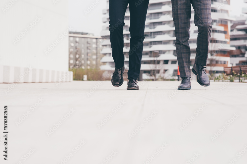 Low section unrecognizable two businessmen walking outdoors. Low section unrecognizable two businessmen walking outdoors.