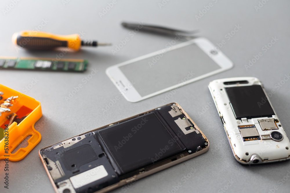 Technician repairing mobile phone at table, closeup Technician repairing mobile phone at table, closeup