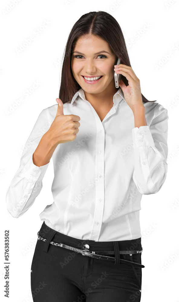 Young woman talking on mobile phone showing thumb up sign Young woman talking on mobile phone showing thumb up sign