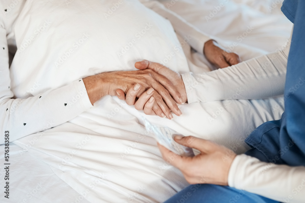 Fototapeta premium Give someone your hand and you give them hope. Cropped shot of a nurse holding hands with a senior woman.
