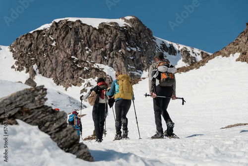 group of mountaineers doing a route with snowshoes in winter on a sunny day in the pyrenees photo