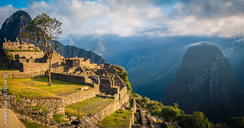 Aerial above Machu Picchu Valley, Inca Trail, Terraces, Temple, Peru with Andean Cordillera Shining in the Background, UNESCO Protected Site