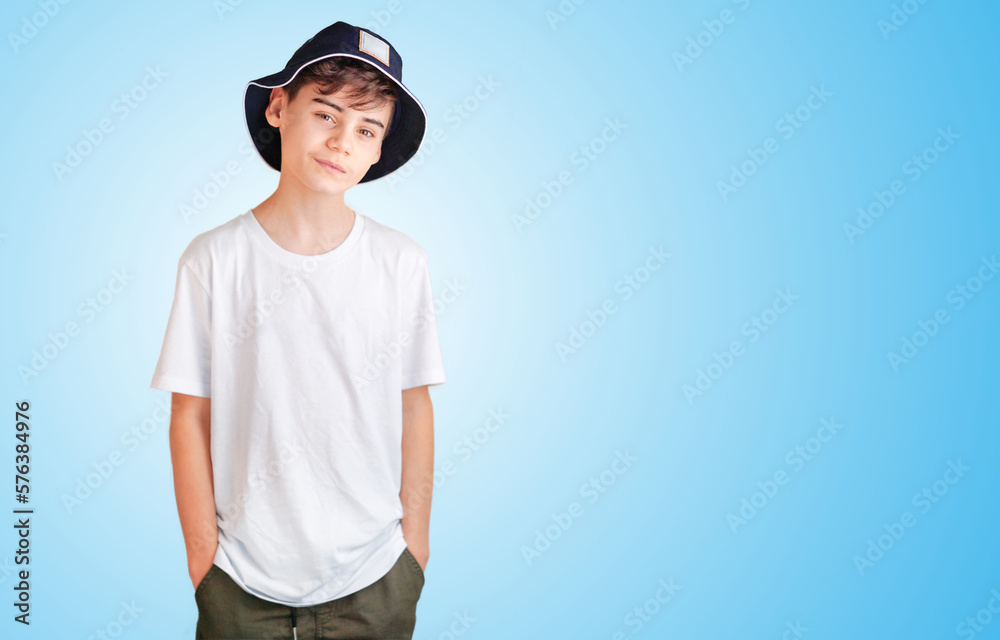 Portrait of nice cheerful smiling 10-year-old boy isolated on blue background in white shirt. back to school concept mit copy space for text. clever schoolboy exudes joy. back-to-school banner Portrait of nice cheerful smiling 10-year-old boy isolated on blue background in white shirt. back to school concept mit copy space for text. clever schoolboy exudes joy. back-to-school banner