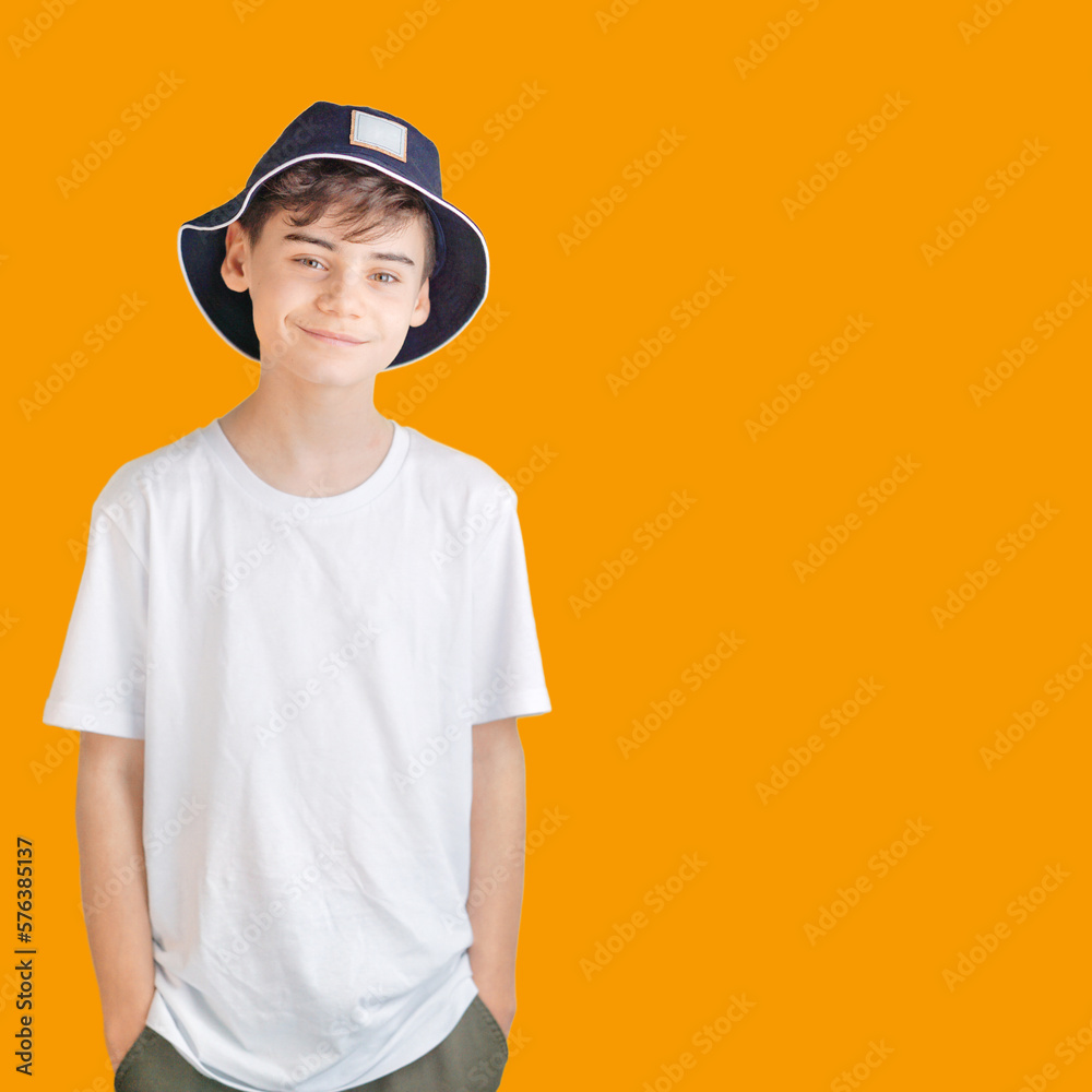 Portrait of nice cheerful smiling 10-year-old boy isolated on orange background in white shirt. back to school concept mit copy space for text. clever schoolboy exudes joy. back-to-school banner