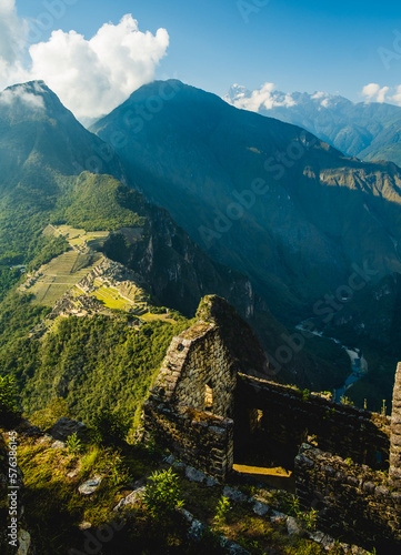 Aerial above Machu Picchu Valley, Inca Trail, Terraces, Temple, Peru with Andean Cordillera Shining in the Background, UNESCO Protected Site