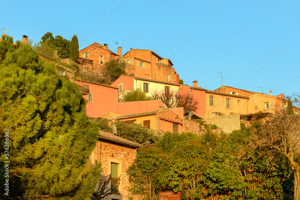 Famous ochre colored houses of Roussillon village in Provence countryside, France