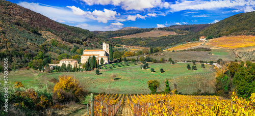 Italy, Toscana autumn scenery . Golden vineyards of Tuscany.  panorama of old monastery and yellow grapewines. photo