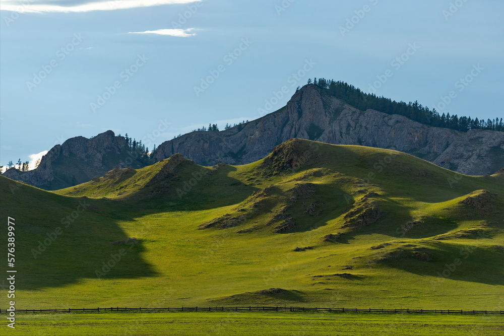 Fototapeta premium Russia. South of Western Siberia, Mountain Altai. Picturesque hilly mountains covered with a solid green carpet with many alpine flowers near the village of Ust-Kan.