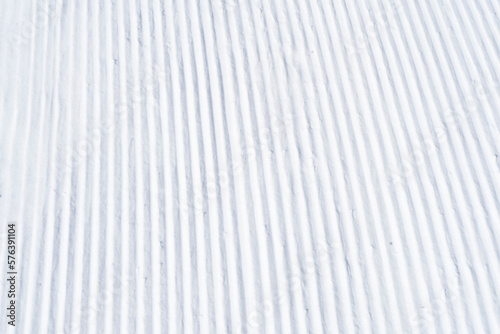 Billede på lærred Close up of groomed tracks on a slope in a downhill ski resort