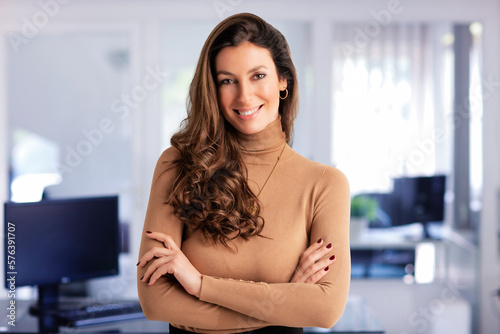 Confident businesswoman standing in a modern office and wearing casual clothes Free Download Confident businesswoman standing in a modern office and wearing casual clothes - GFXLoad