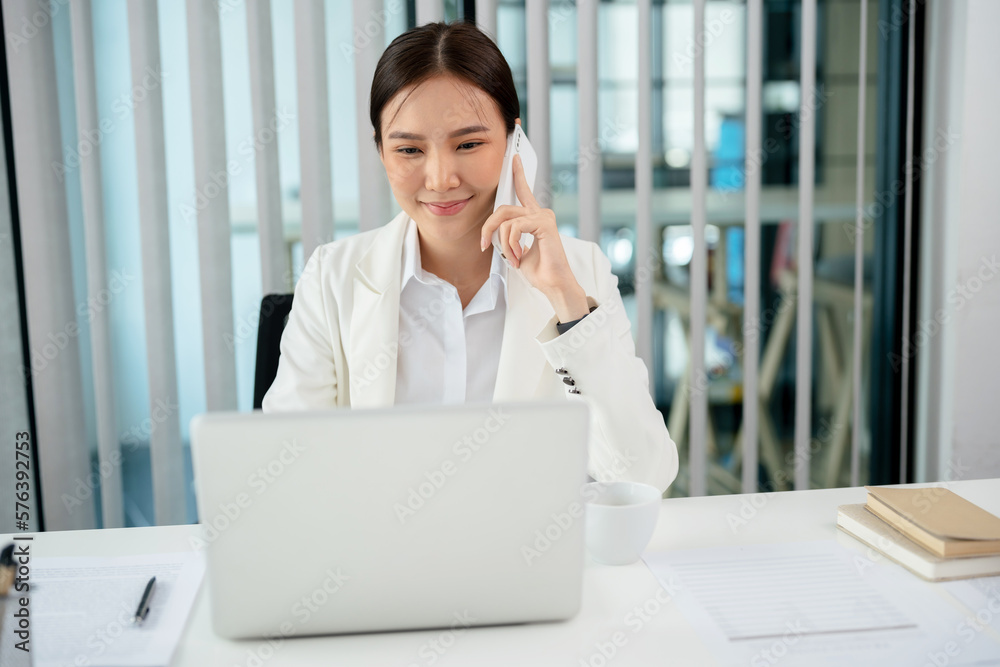 Asian businesswoman working on laptop and mobile phone Start up small business owner. business successful technology concept Asian businesswoman working on laptop and mobile phone Start up small business owner. business successful technology concept