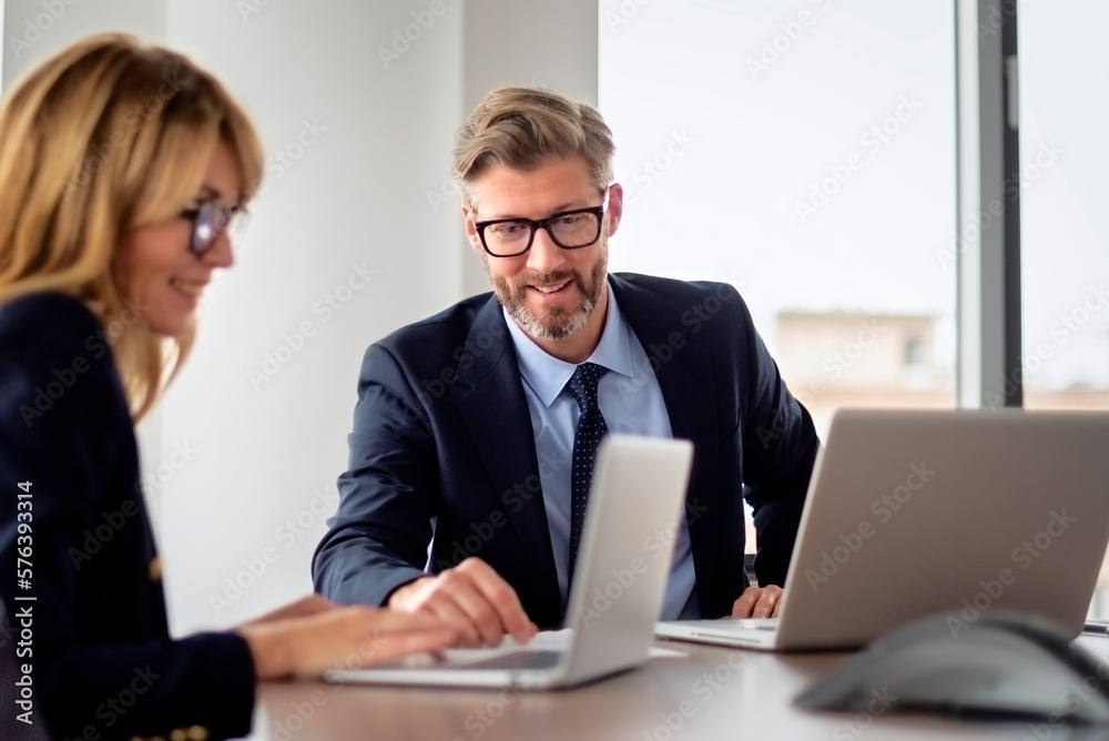 Group of business people having meeting at the boardroom and working on business report Group of business people having meeting at the boardroom and working on business report