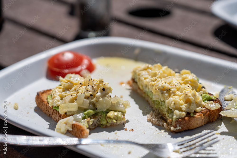 Freshly prepared egg toast with tomato on the side in the morning sunlight Freshly prepared egg toast with tomato on the side in the morning sunlight