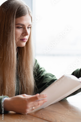 The girl is reading a book. The student is studying scientific literature. Leisure and rest.