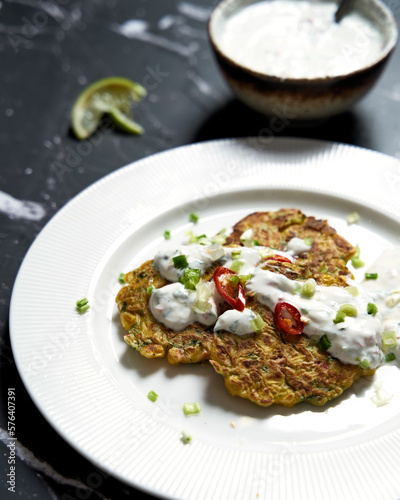 Pancakes with corn and yogurt sauce with lime and chili. 