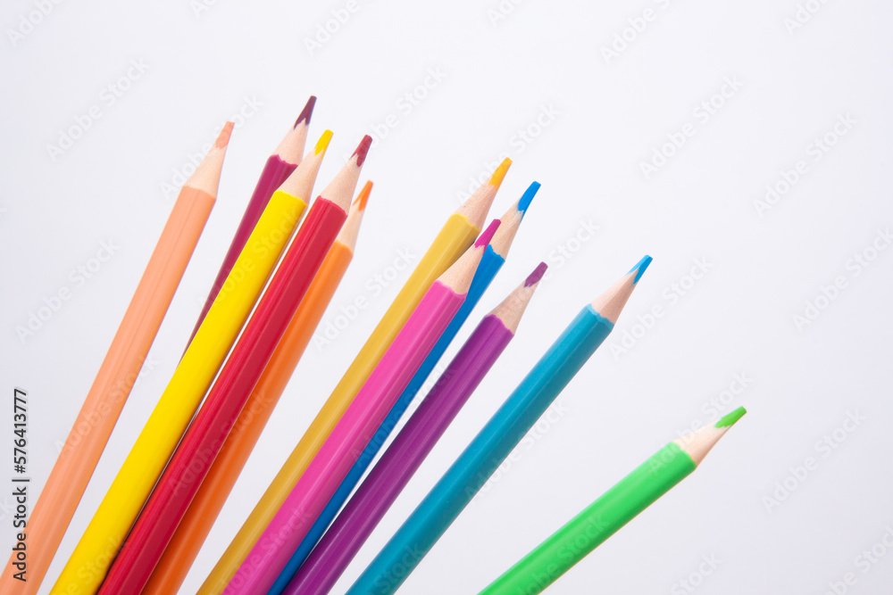 Different colors pencils - art card with drawing stationery on white background Different colors pencils - art card with drawing stationery on white background