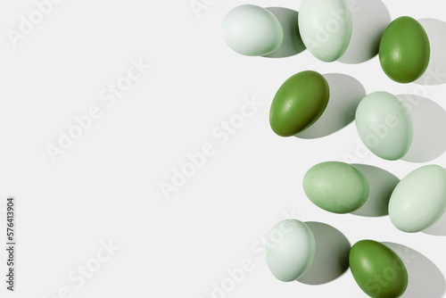 Easter eggs green gradient color with hard Shadow at sunlight  frame and light background. Chicken egg on table  top view  minimal flat lay  holiday food still life  design element  backdrop