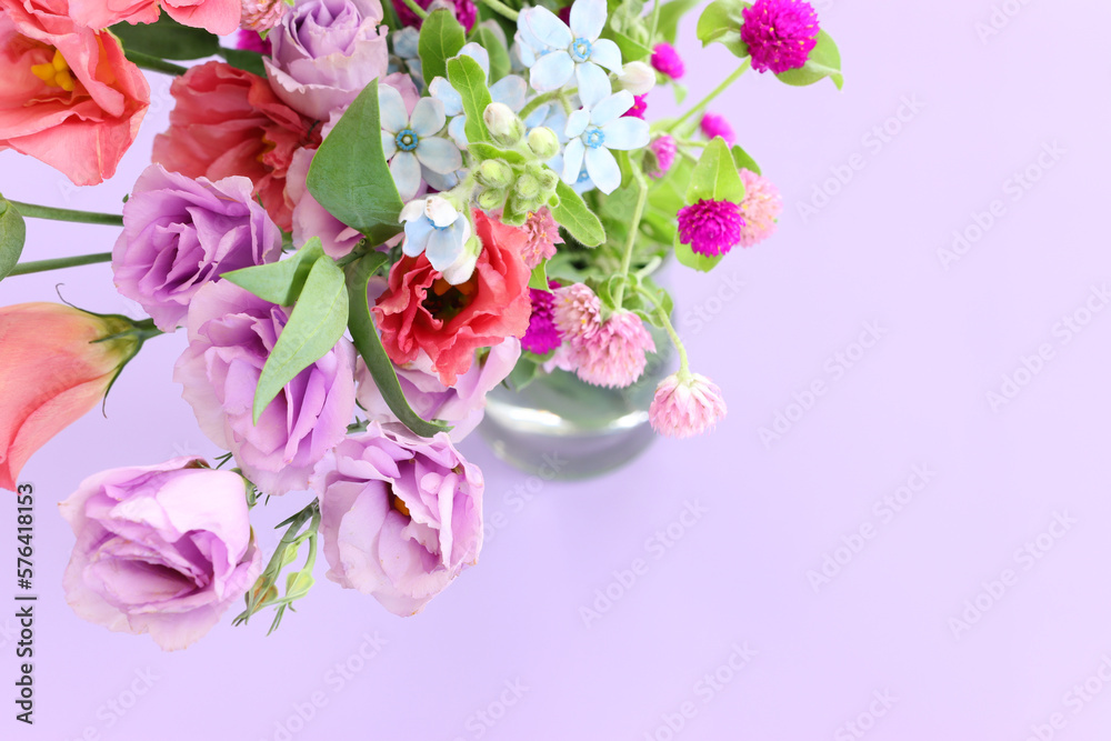 Top view image of pink and purple flowers composition over pastel background Top view image of pink and purple flowers composition over pastel background