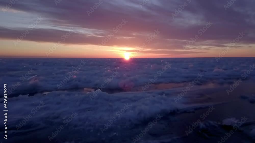 Aerial: Drone Shot Of Frozen Ice On Lake Under Cloudy Sky During Sunset - Marquette, Michigan Aerial: Drone Shot Of Frozen Ice On Lake Under Cloudy Sky During Sunset - Marquette, Michigan