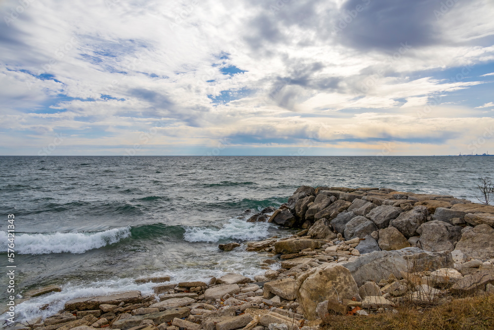 Clouds hover over the wavy water of Lake Ontario on a windy day in Sam Smith Park in Toronto.