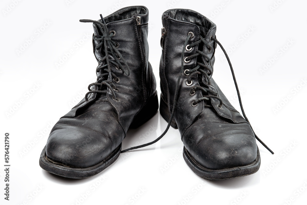 A pair of worn men's leather boots Isolated on a white background. A pair of worn men's leather boots Isolated on a white background.