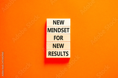 New mindset and results symbol. Concept words New mindset for new results on wooden blocks. Beautiful orange table orange background. Business new mindset for results concept. Copy space