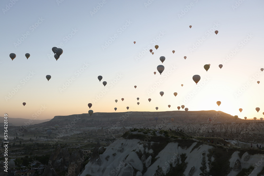 Panoramic view landscape with hot air balloons, sunrise and mountains on background