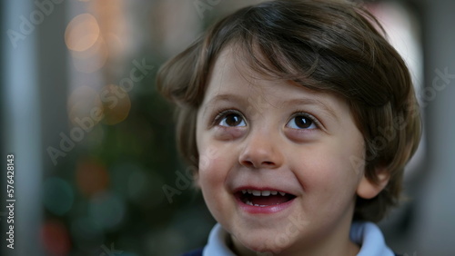 One excited little boy face close up. Surprised adorable 2 year old kid portrait. Fun happy authentic reaction