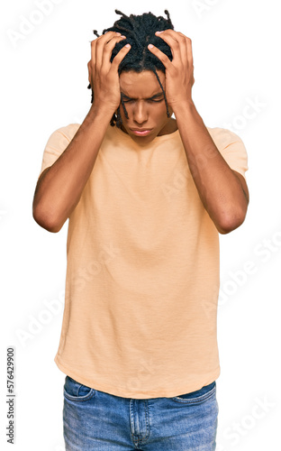 Young african american man wearing casual clothes suffering from headache desperate and stressed because pain and migraine. hands on head.