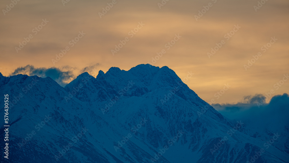 February evening. View from Czorsztyn to the Tatra Mountains against the background of the setting sun February evening. View from Czorsztyn to the Tatra Mountains against the background of the setting sun