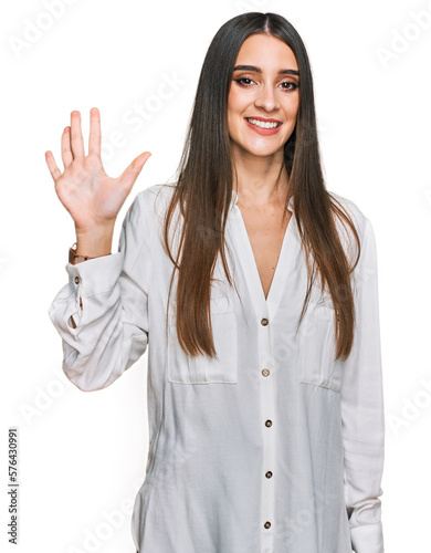 Young beautiful woman wearing casual white shirt showing and pointing up with fingers number five while smiling confident and happy.