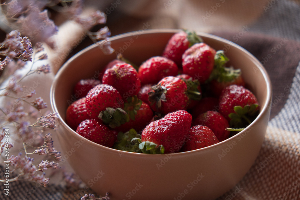 Fresh strawberries in a plate on a checkered plaid. High quality photo Fresh strawberries in a plate on a checkered plaid. High quality photo