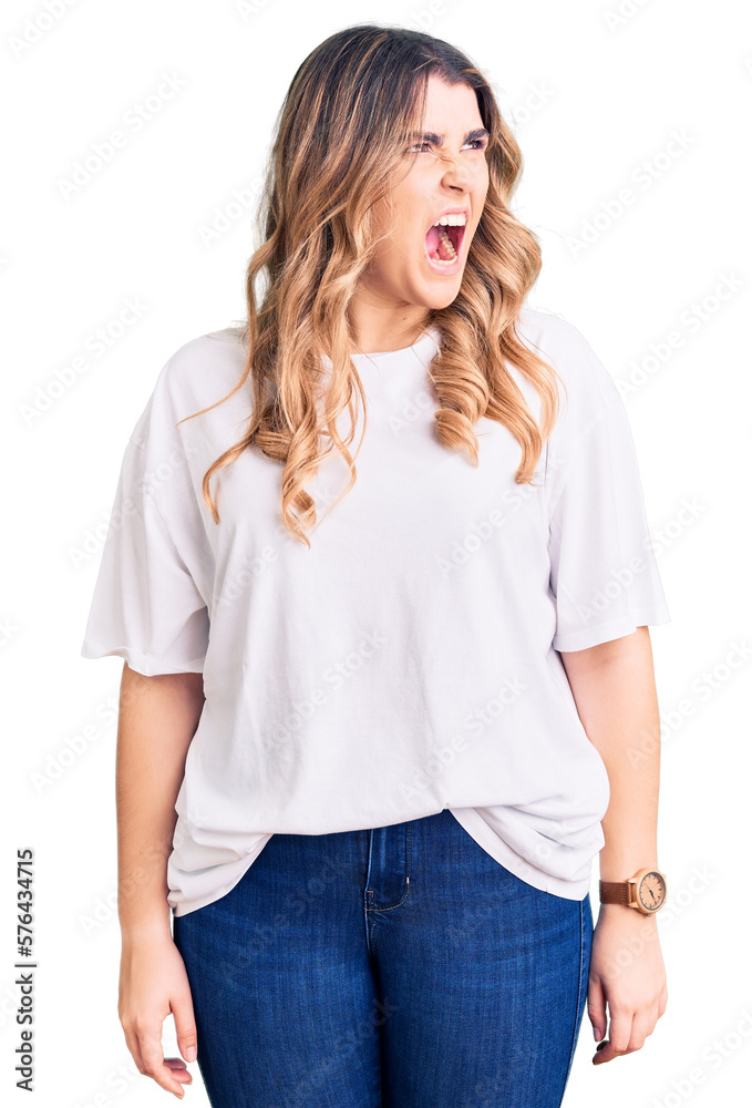 Fototapeta premium Young caucasian woman wearing casual clothes angry and mad screaming frustrated and furious, shouting with anger. rage and aggressive concept.