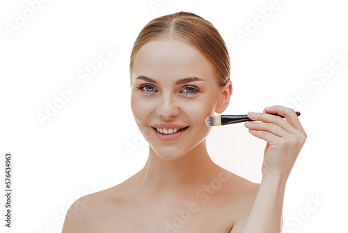 close-up portrait of a girl without makeup with clean skin with a makeup brush in hand  isolated on a white background