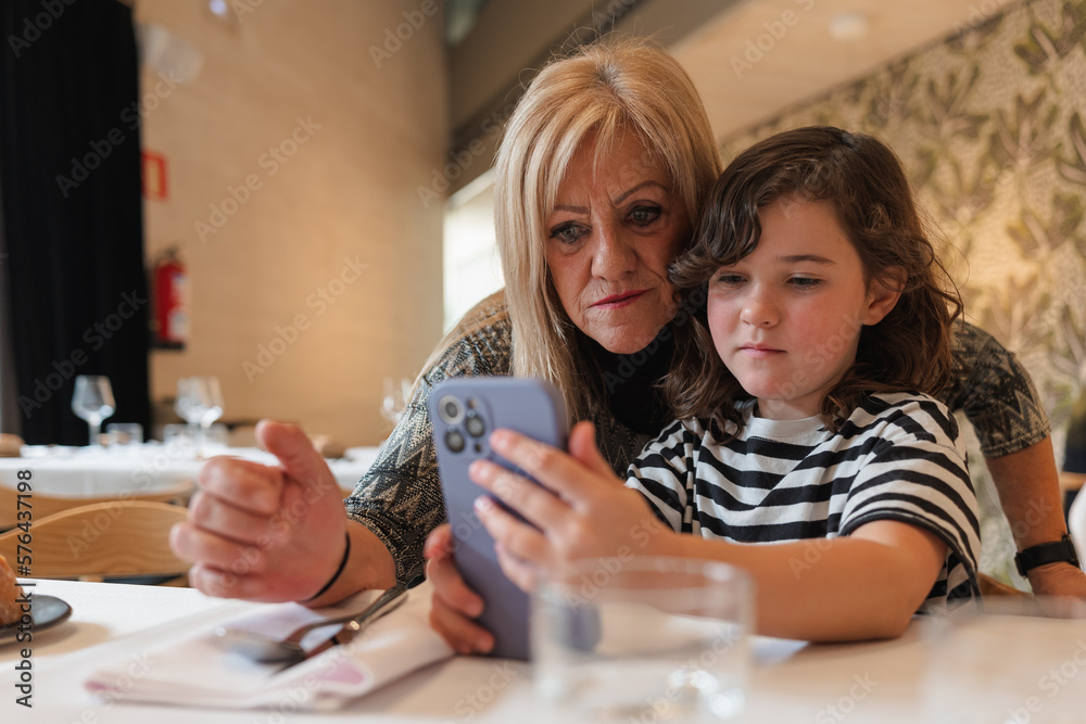 Woman and girl taking selfie on smartphone Woman and girl taking selfie on smartphone