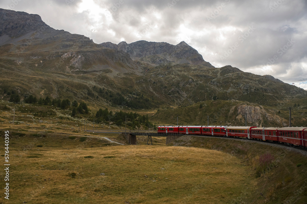 Train of Rhaetian Railway riding in a mountain landscape in canton Graubünden, South-East Switzerland