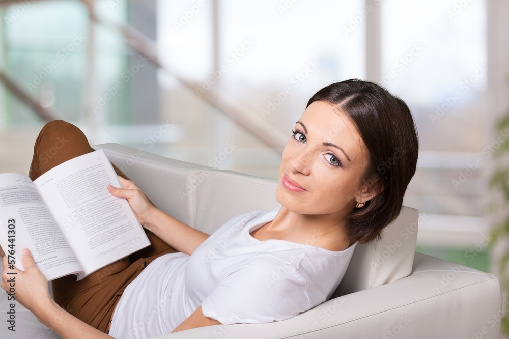 Young woman reading a book, relaxing at home. Young woman reading a book, relaxing at home.