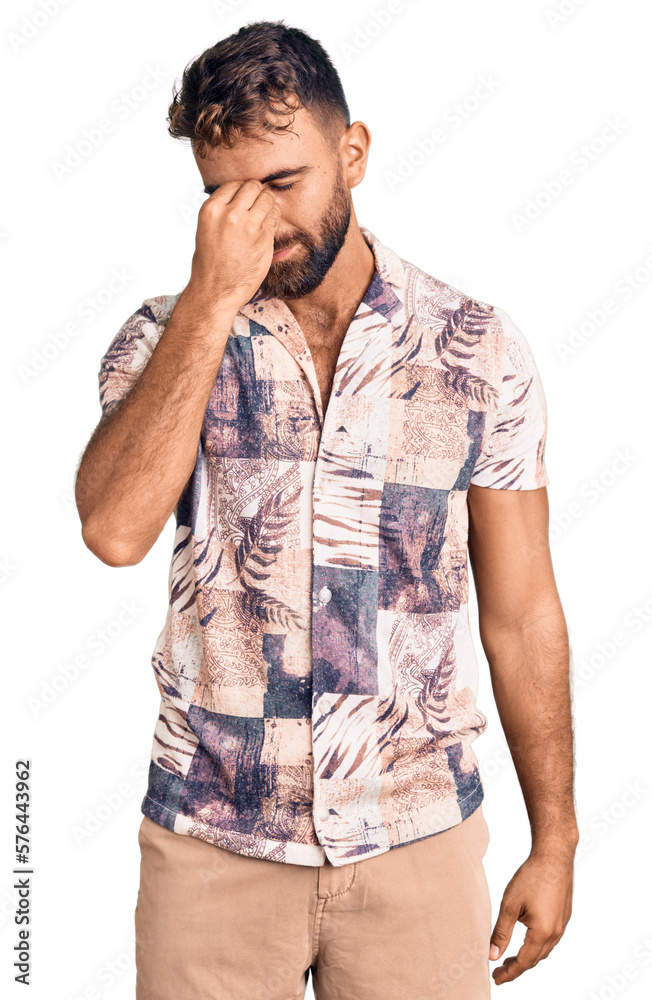 Young hispanic man wearing summer clothes tired rubbing nose and eyes feeling fatigue and headache. stress and frustration concept. Young hispanic man wearing summer clothes tired rubbing nose and eyes feeling fatigue and headache. stress and frustration concept.