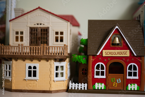 Red school house with bell plastic toy.