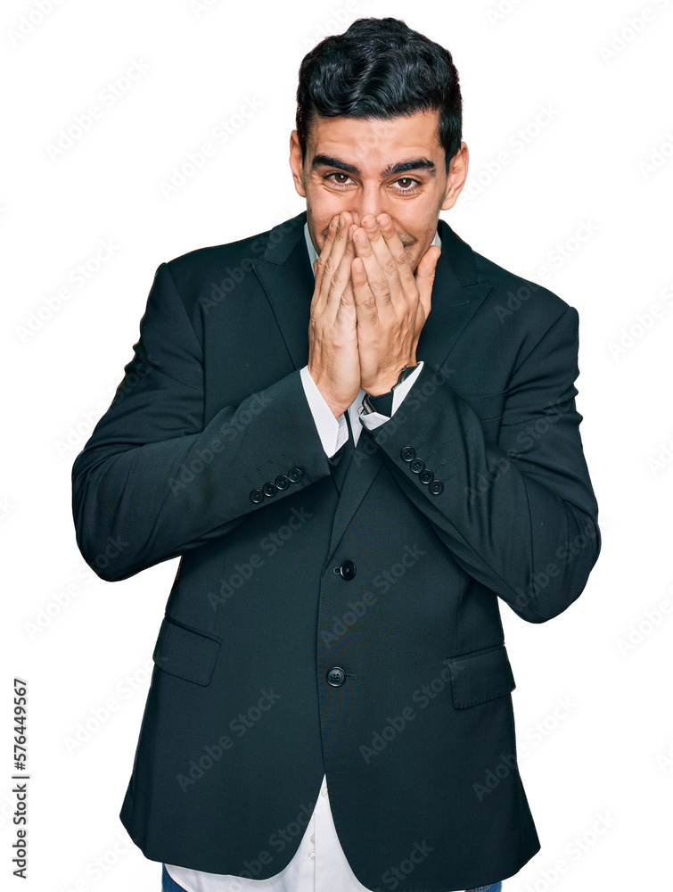 Handsome hispanic man wearing business clothes laughing and embarrassed giggle covering mouth with hands, gossip and scandal concept Handsome hispanic man wearing business clothes laughing and embarrassed giggle covering mouth with hands, gossip and scandal concept