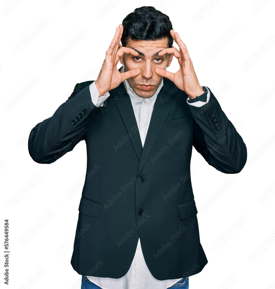 Handsome hispanic man wearing business clothes trying to open eyes with fingers, sleepy and tired for morning fatigue Handsome hispanic man wearing business clothes trying to open eyes with fingers, sleepy and tired for morning fatigue