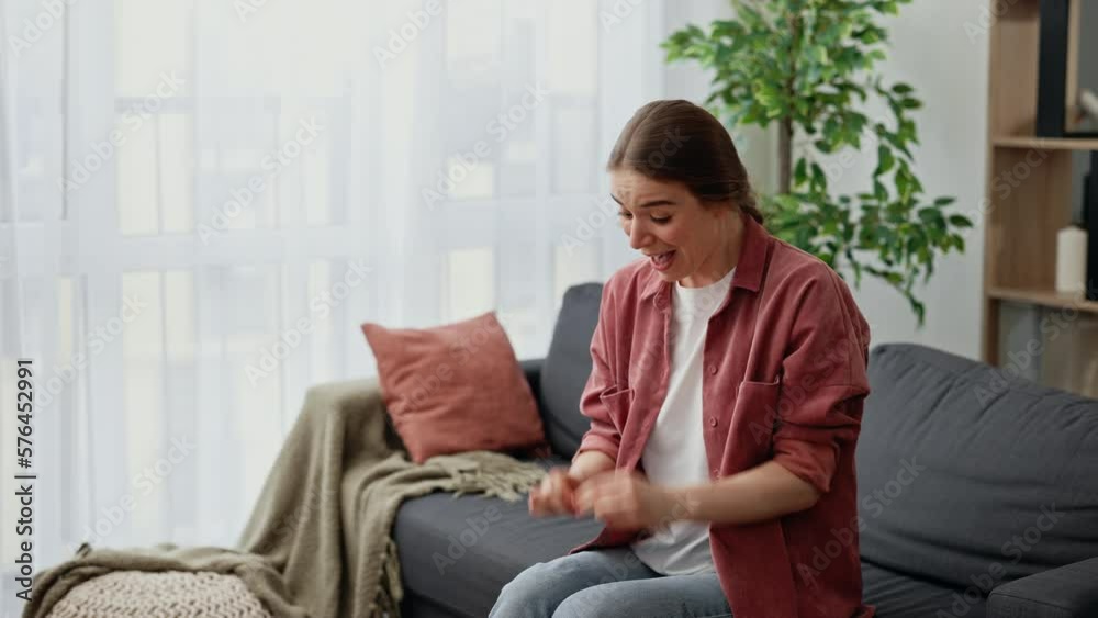 Overjoyed Young Woman Holding Pregnancy Test Stick Sitting on Sofa at Home. Pregnant Lady Surprised and Happy Expecting Baby, Feeling Excited Positive Result on Tester after IVF Treatment in Clinic Overjoyed Young Woman Holding Pregnancy Test Stick Sitting on Sofa at Home. Pregnant Lady Surprised and Happy Expecting Baby, Feeling Excited Positive Result on Tester after IVF Treatment in Clinic