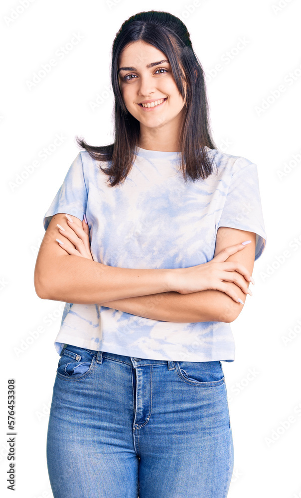 Young beautiful girl wearing casual t shirt happy face smiling with crossed arms looking at the camera. positive person. Young beautiful girl wearing casual t shirt happy face smiling with crossed arms looking at the camera. positive person.