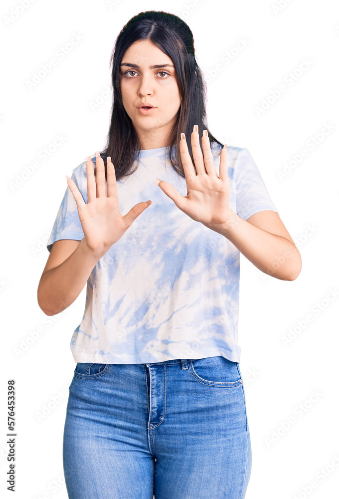 Young beautiful girl wearing casual t shirt moving away hands palms showing refusal and denial with afraid and disgusting expression. stop and forbidden. Young beautiful girl wearing casual t shirt moving away hands palms showing refusal and denial with afraid and disgusting expression. stop and forbidden.