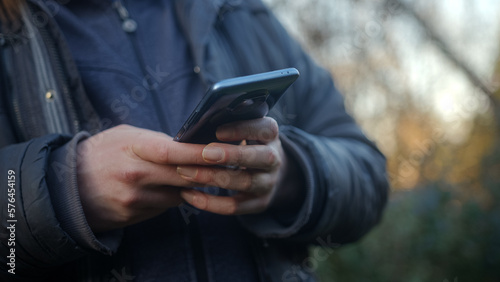 Close-up of Hands Using Smartphone and App