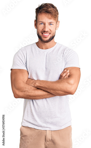 Young caucasian man wearing casual white tshirt happy face smiling with crossed arms looking at the camera. positive person.