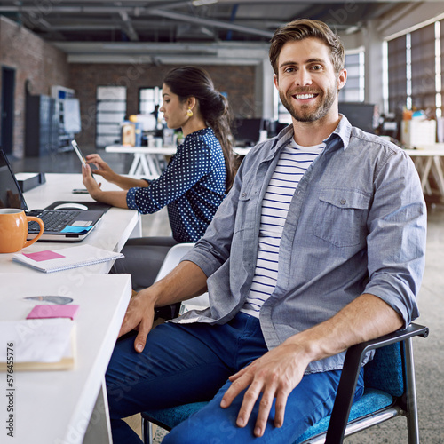 Confidence, smile and portrait of man at desk with laptop and woman at creative agency working on project together. Leadership, collaboration and happy employees or business people at design startup.