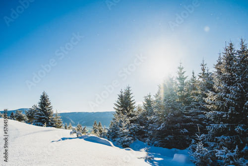 Alpine mountains landscape with white snow and blue sky. Sunset winter in nature. Frosty trees under warm sunlight.  Hiking winter to kralova hola, low tatras slovakia landscape photo